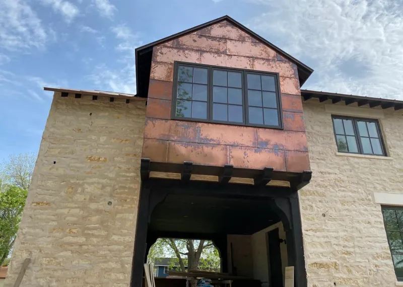 Copper metal panel facade on a stone building for Skylight Installation in Fort Valley