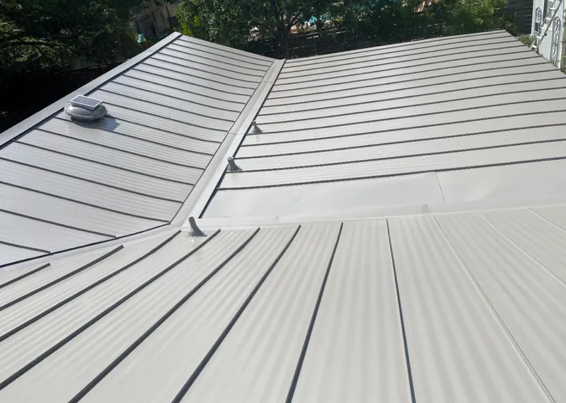 Solar attic fan installed on a metal roof for Roof Ventilation in Fort Valley